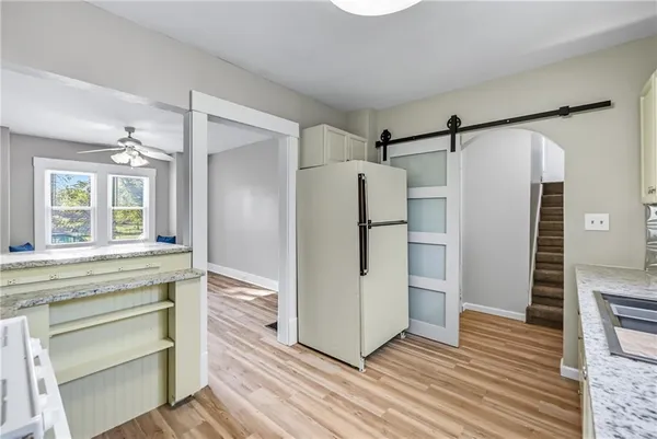 a kitchen with a stove a refrigerator and a sink