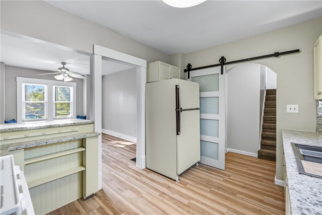 1039 North Keel Ridge Road Hermitage, PA 16148 - Photo 14 of 47 a kitchen with granite countertop a refrigerator and a wooden floor