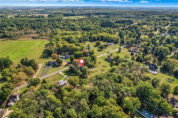 an aerial view of a houses with a yard