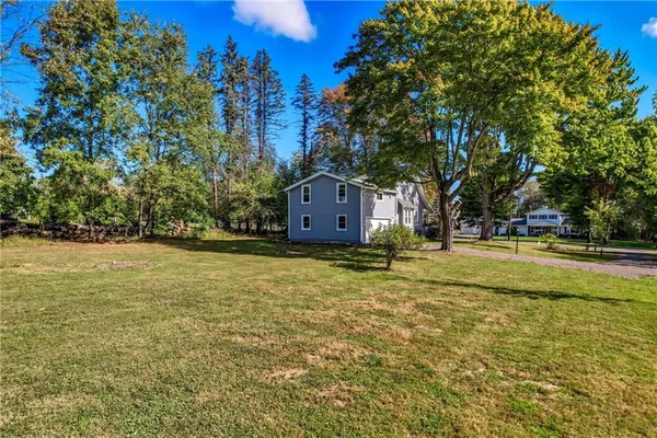 a backyard of a house with a yard and outdoor seating
