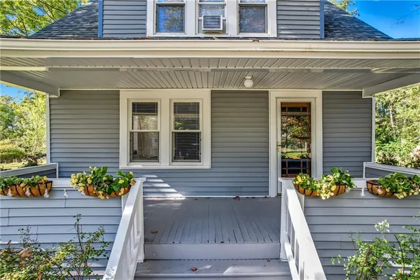 a front view of a house with a large window