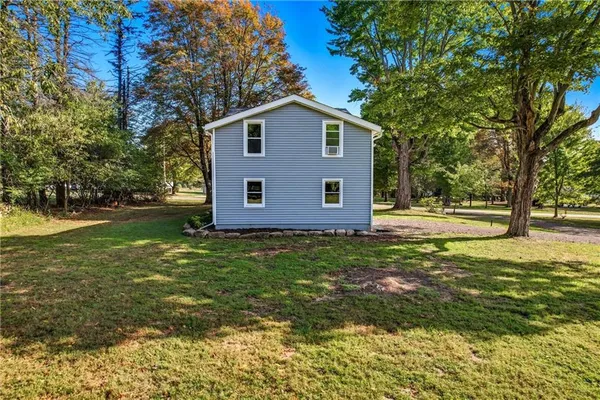 a front view of a house with a yard