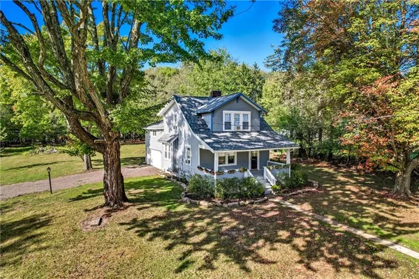a front view of a house with outdoor seating