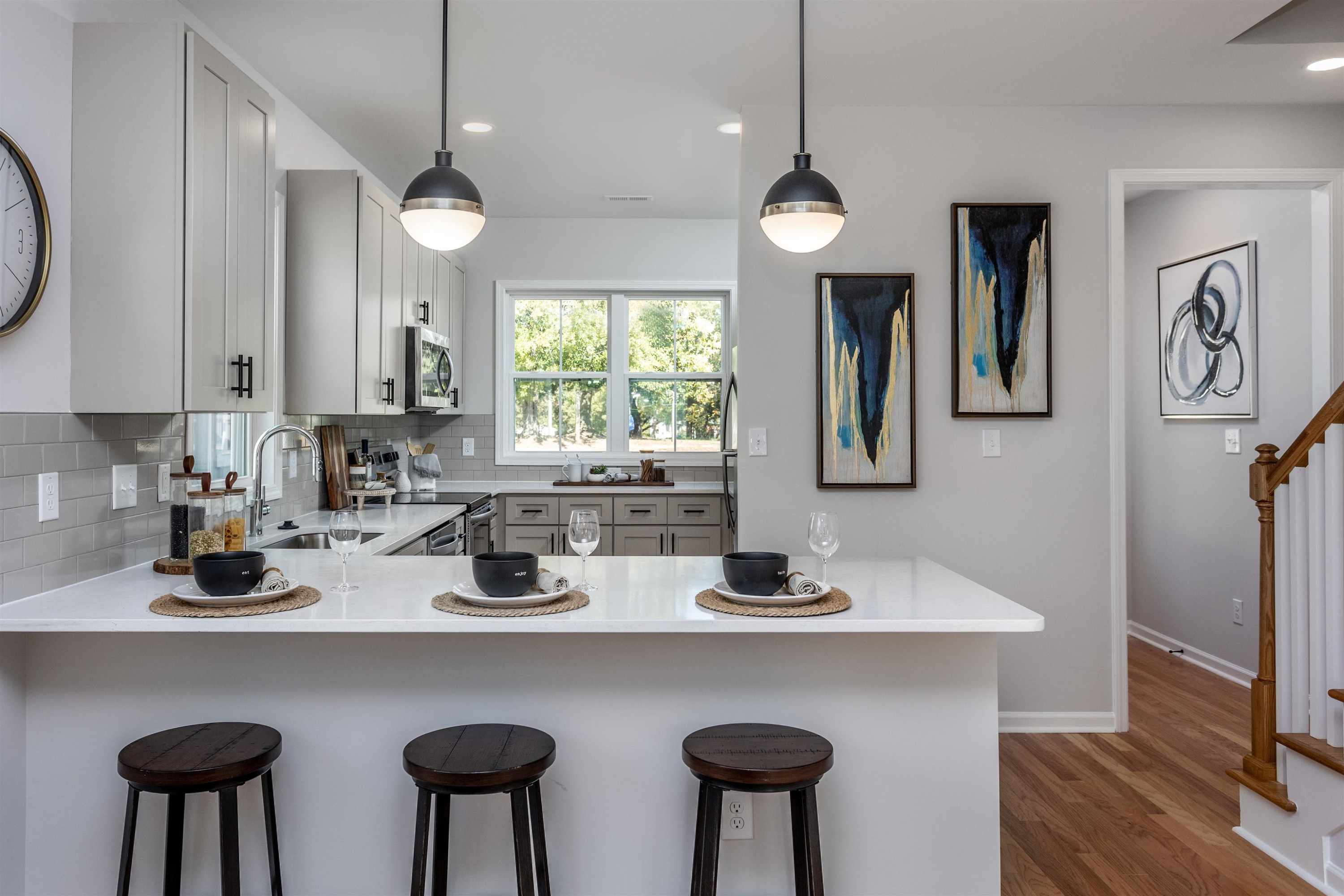 622 Rush Street Raleigh, NC 27610 - Photo 3 of 26 a kitchen with stainless steel appliances a table chairs and a refrigerator
