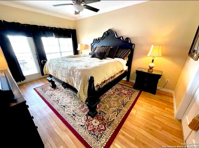 a bedroom with a bed and wooden floor