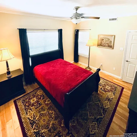 a bed sitting in a bedroom next to a window