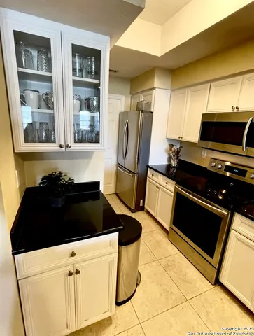 a kitchen with a stove and a refrigerator
