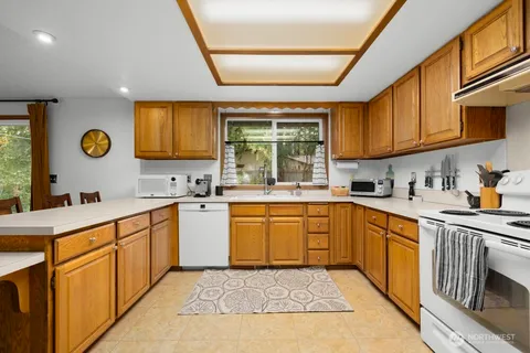 a kitchen with a sink window and cabinets