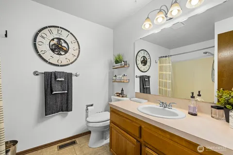 a bathroom with a toilet a sink and a mirror