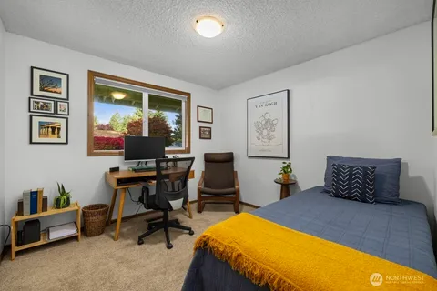 a bedroom with furniture and a window