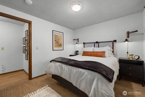 a bedroom with a bed and a night stand