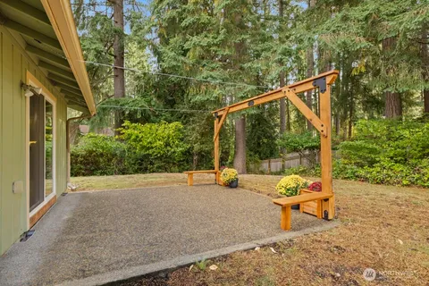 a backyard of a house with table and chairs