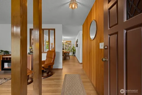 a view of a hallway with furniture and entryway