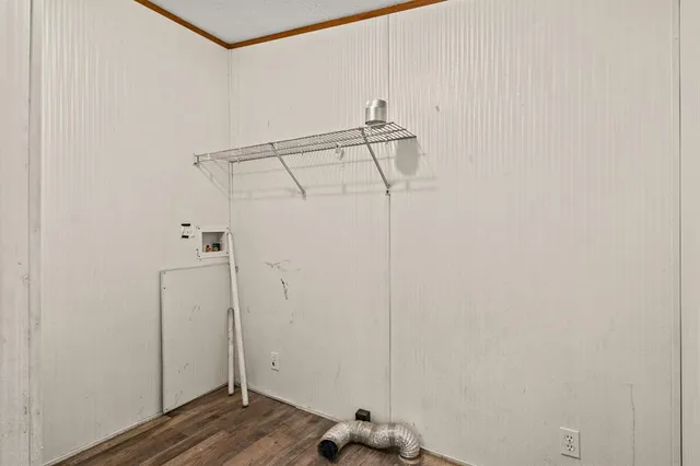 a view of a room with wooden floor