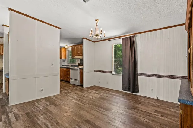 a view of a refrigerator in kitchen and wooden floor