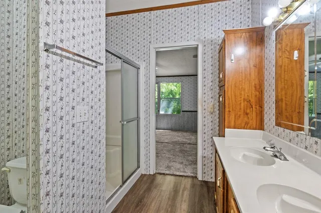 a bathroom with a sink a mirror and a shower