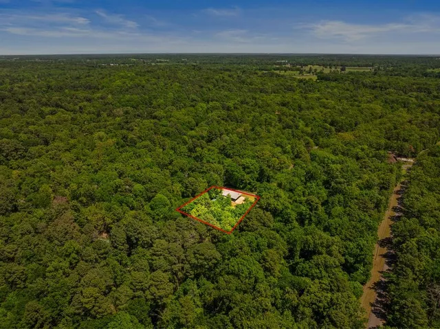 an aerial view of residential houses with outdoor space and river