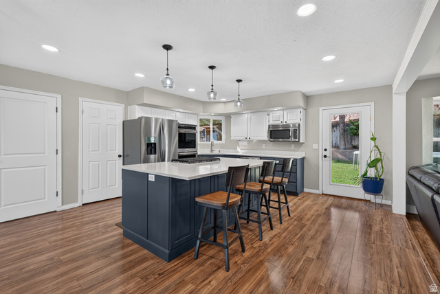 1690 Maplewood Way St. George, UT 84790 - Photo 3 of 17 Kitchen featuring wood-finish flooring, recessed lighting, and a center island with countertop seating