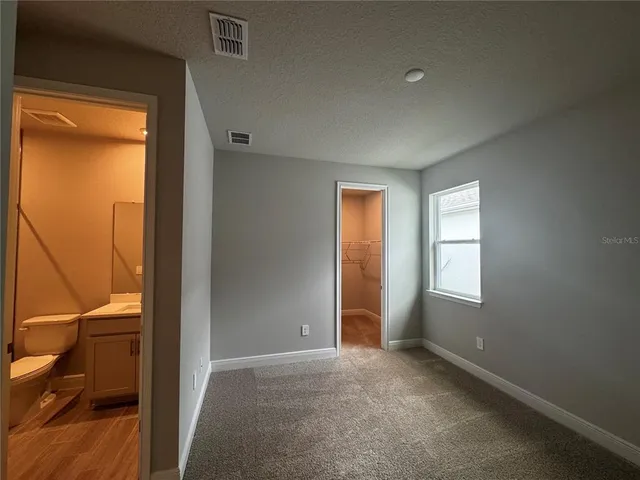 a view of hallway with livingroom and window