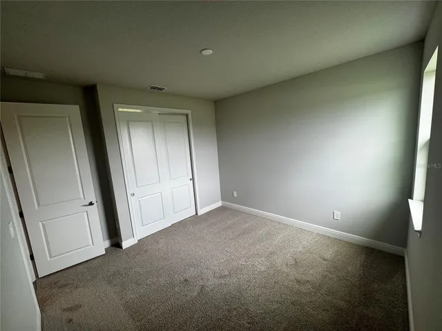 a view of an empty room and a window