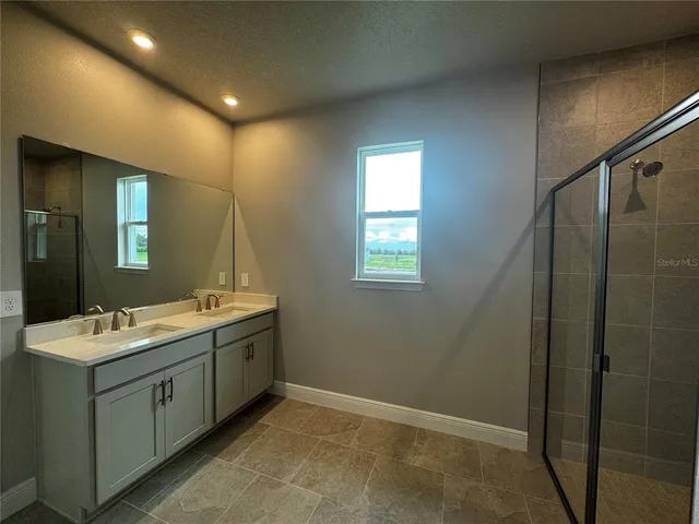 a bathroom with a double vanity sink and mirror