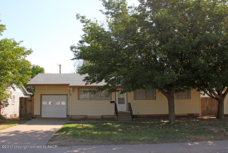 5127 Crockett Street Amarillo, TX 79110 - Photo 1 of 25 a front view of a house with a yard and a garage