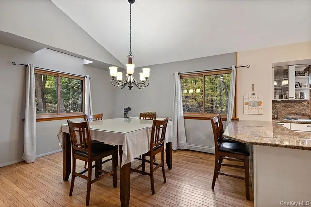 a living room with furniture a large window and flat screen tv
