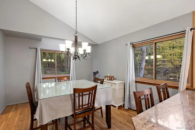 a kitchen with stainless steel appliances granite countertop a kitchen island a stove a table and chairs in it