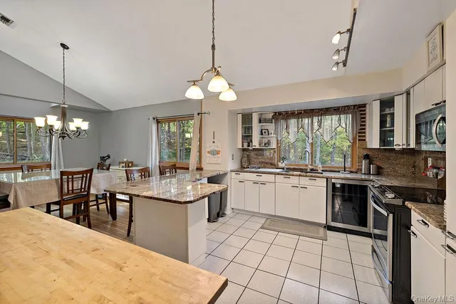 a kitchen with a sink stove top oven and cabinets
