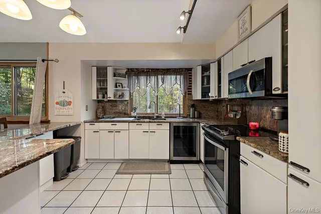 a kitchen with a stove a sink and a microwave