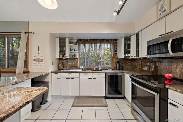 a kitchen with a refrigerator sink and microwave