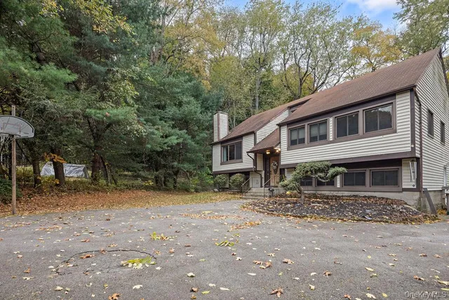 a house that has a tree in front of it