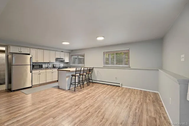 a kitchen with stainless steel appliances cabinets a sink and a window