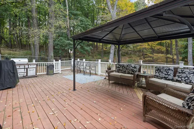 a view of a house with a bench and trees