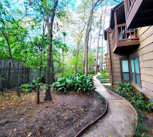 a view of a pathway with a house in the background