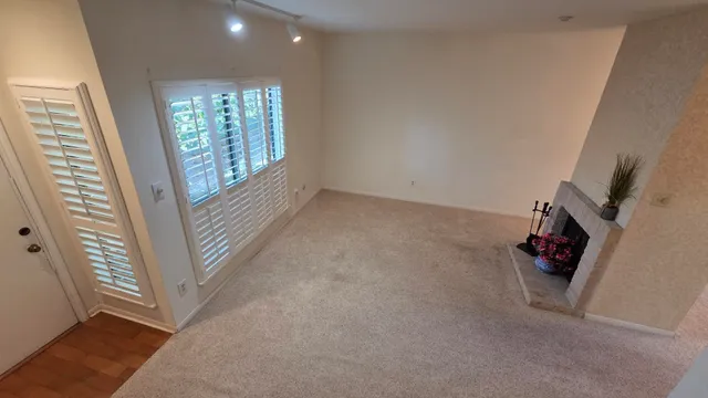 a view of an empty room with windows