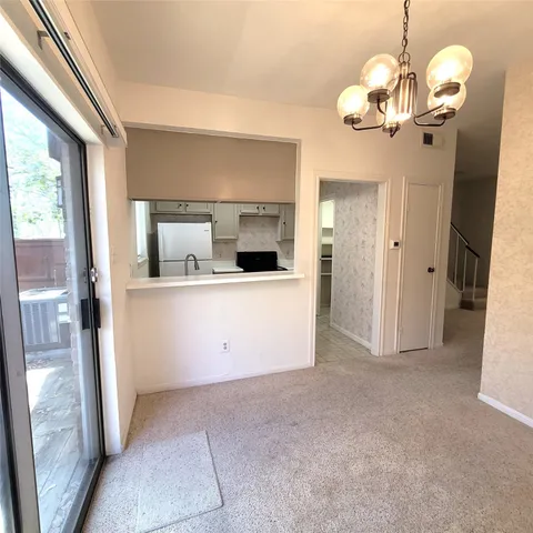 a view of a kitchen cabinets and a chandelier