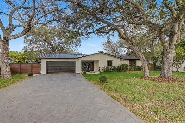a front view of house with yard and trees