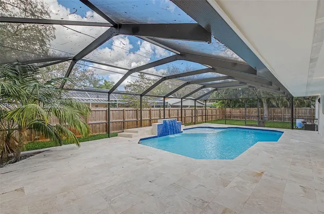 a view of a house with a yard and tree s