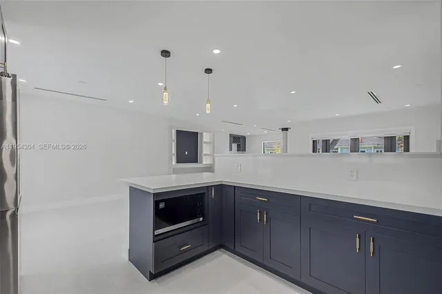 a kitchen with stainless steel appliances granite countertop a refrigerator and a sink