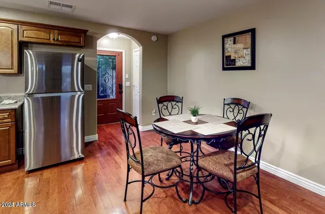 a view of a dining room with furniture and wooden floor