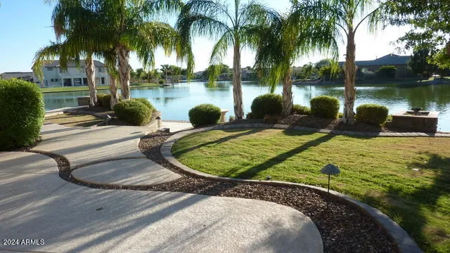 a view of a swimming pool with a patio and a lake view