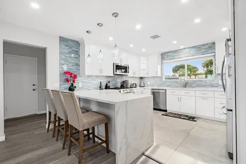 a kitchen with a table and chairs in it