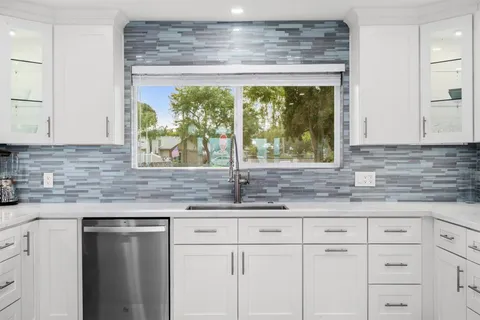 a kitchen with a sink and large window