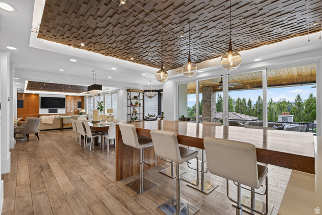 12308 Mariah Circle Draper, UT 84020 - Photo 45 of 293 Spacious open-concept living area featuring a decorative wood-panel ceiling with recessed lighting, wood-finish flooring, and a large wood island with seating