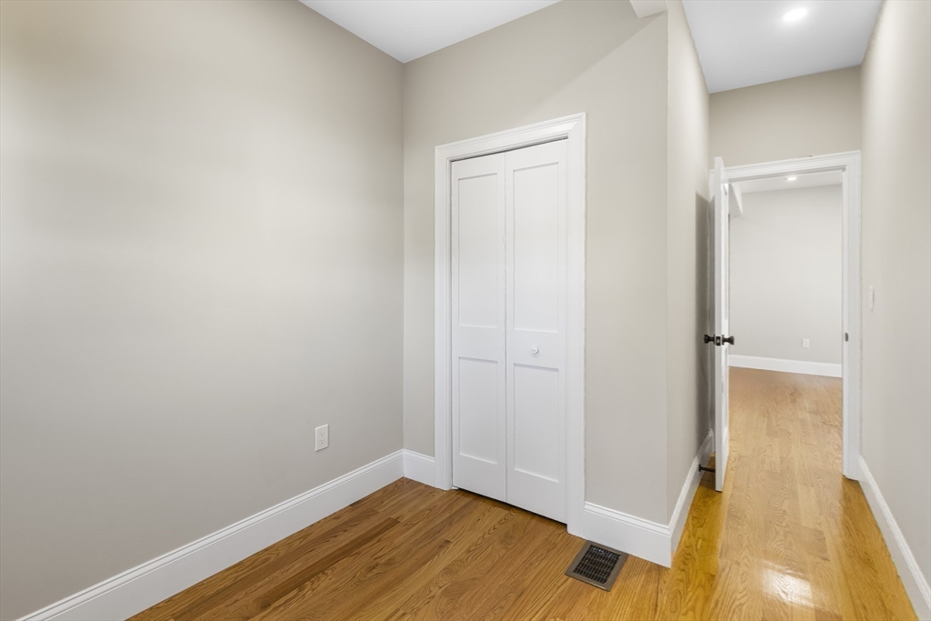 31 Woodale Avenue, Unit 1 Boston, MA 02126 - Photo 11 of 22 wooden floor in an empty room