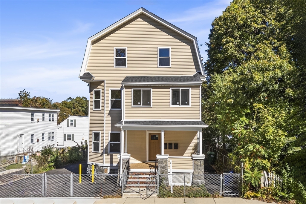 31 Woodale Avenue, Unit 1 Boston, MA 02126 - Photo 14 of 22 a front view of a house with a yard