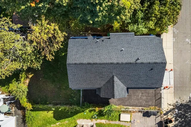 an aerial view of a house with a yard