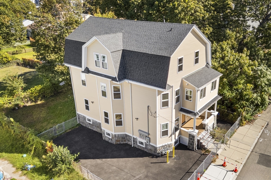 31 Woodale Avenue, Unit 1 Boston, MA 02126 - Photo 19 of 22 a front view of a house with a yard