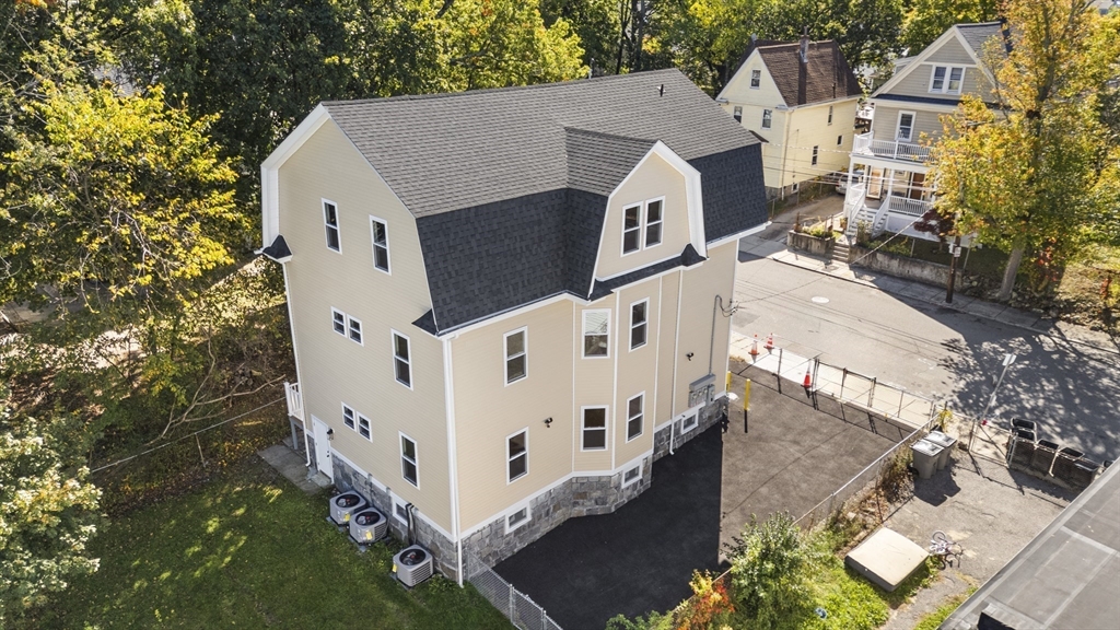 31 Woodale Avenue, Unit 1 Boston, MA 02126 - Photo 20 of 22 aerial view of a house with wooden fence